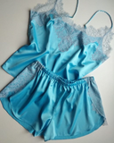 Bright blue silk pajama set with lace trim. Sleep wrap shorts with side slits.